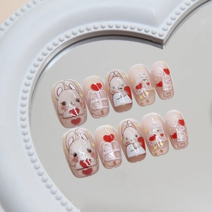 Cat eye press-on nails with cute bunny and heart designs in a soft pink finish
