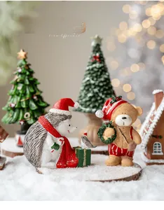 Miniature resin Christmas figurine set featuring hedgehog and bear in a cozy scene