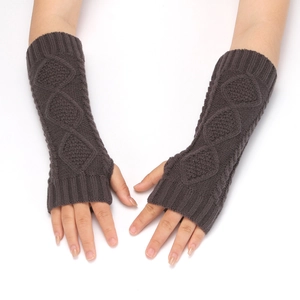 Detailed knit texture of dark coffee arm warmers with classic diamond cable pattern