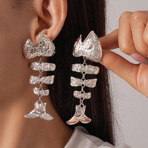Exaggerated silver metal fishbone drop earrings with articulated joints and intricate texture