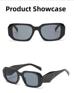 Detail of black geometric sunglasses showing 3D faceted frame and dark grey lenses