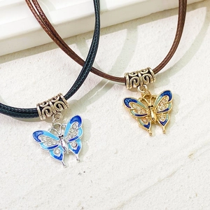 Vintage butterfly pendant necklace with colorful enamel and leather cord layers