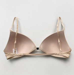 Detail of nude triangle bra showing seamless fabric texture and adjustable thin straps