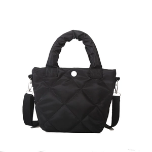 Chic black quilted bucket bag in shiny nylon with scrunchie handle and shoulder strap