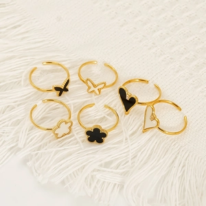 Set of six gold clover and heart open rings with black and white enamel inlays
