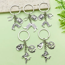 Detailed view of silver alloy cowboy-themed keychains with hat and horseshoe charms