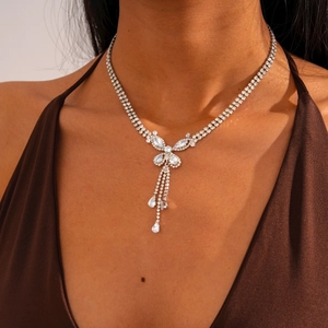 Detail of silver butterfly tassel necklace with sparkling rhinestones worn on neck