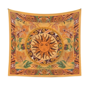 Close-up of bohemian moon phase tapestry featuring intricate sun face and tarot motifs