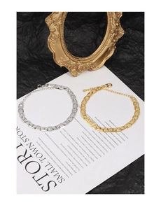 Detail of gold and silver Marina chain bracelets with lobster clasp and extension