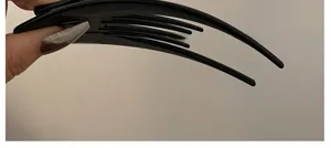 Detail shot of a black glossy acetate multi-tooth hair clip for securing hair buns