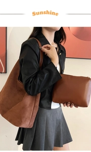 Detail of caramel brown suede tote bag and matching leather pouch worn by a model