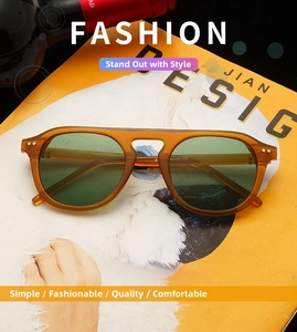Top view of vintage amber sunglasses with green lenses on a yellow magazine cover