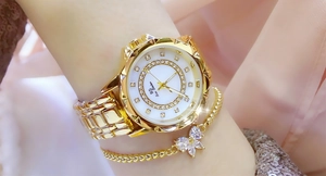 Close-up of gold ladies watch with crystal dial and matching butterfly bracelet