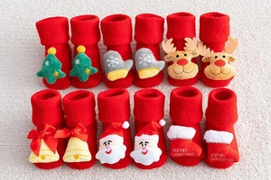 Detailed close-up of thick Christmas baby socks featuring festive 3D cartoon ornaments