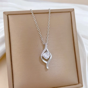 Macro shot of silver titanium necklace with curved pendant and sparkling zircon stones