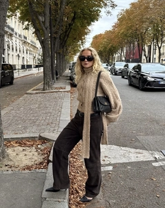 Detail of camel chunky knit cardigan set with matching scarf and high-waist brown pants