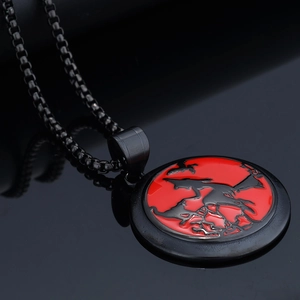 Detail shot of gothic black metal pendant with red dragon motif and square bead chain