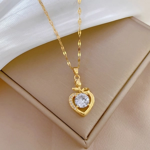 Luxurious gold titanium heart necklace with shimmering zircon pendant on jewelry box
