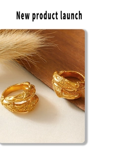 Detailed close-up of textured gold rings with scale patterns and 18k gold plating