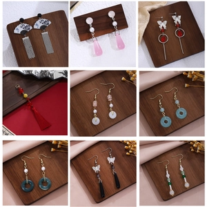 Detail of traditional Chinese butterfly tassel earrings with pearls and jade charms