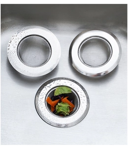 Macro shot of stainless steel sink strainer with food waste in a kitchen sink