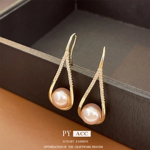 Elegant gold plated drop earrings with crystals and pearls in a black jewelry box