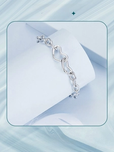 Close-up of S925 sterling silver chain bracelet with double interlocking heart clasp