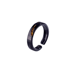 Detail of adjustable black and gold textured ring featuring minimalist kintsugi style design