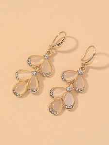 Detail of elegant leaf earrings with pink opal stones and sparkling crystal accents