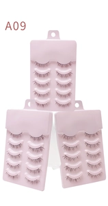 Detail view of 15 pairs of natural long black false eyelashes in a pink display tray