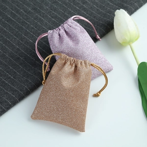 Glittery purple and gold drawstring pouches for jewelry storage and gift packaging