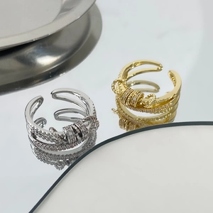 Adjustable cross-over spinner rings in gold and silver finish with zircon stones