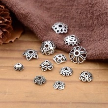 Macro shot of antique silver S925 spacer beads with vintage hollow-out floral patterns