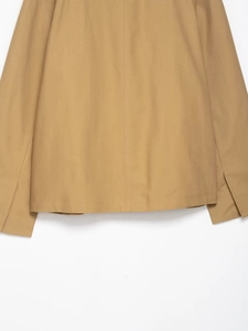 Detailed view of khaki cropped jacket hem and sleeves with premium textured cotton fabric