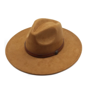 Detail of tan faux suede fedora hat with brown leather band and embossed pattern