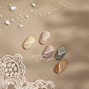 Macro shot of 3D embossed lace patterns on assorted color press-on nails