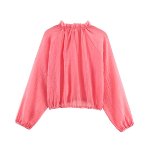 Detailed view of pink pleated fabric texture with ruffle collar and elastic hemline