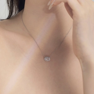 Close-up of S925 sterling silver halo necklace with oval zircon worn by a model