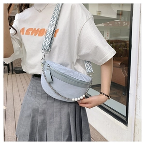 Detail of light blue wrinkled crossbody bag with pearl chain and geometric strap