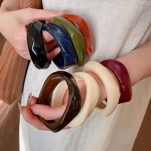 Macro detail of thick geometric acrylic resin bangles in various tortoiseshell patterns