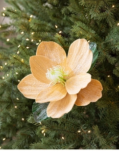 Detail of glitter champagne lotus flower ornament on Christmas tree background