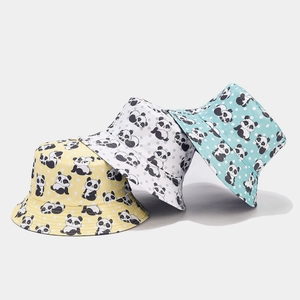 Detail of cartoon panda pattern on yellow, white, and blue cotton reversible bucket hats