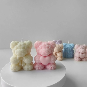 Detail view of colorful rose bear candles with intricate textures and heart decorations