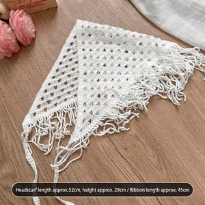 Detail of white crochet hollow triangle headscarf showing 52x29cm dimensions and ties