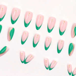 Long almond press-on nails featuring green French tips with gold wave lines and foil dots