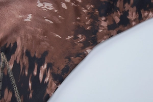 Macro detail of leopard print fabric texture with high-quality overlock stitching edge