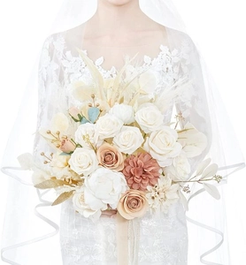 Detailed close-up of bridal bouquet with white and champagne silk roses and dried grass