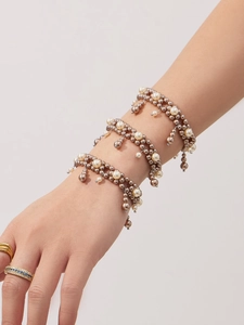 Detail of grey pearl beaded bracelet with stainless steel chain and gourd tassel charm