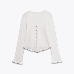 White V-neck knitted cardigan with gold buttons and ruffled hem in soft cotton blend