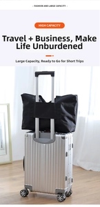 Detailed view of black travel bag with trolley sleeve secured on silver luggage